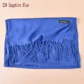 Detail of royal blue cashmere-like scarf showing soft texture and tassel fringe edges - Sapphire Blue