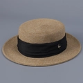 Detailed macro shot of straw texture with black ribbon and gold metal emblem - M (56-58cm) / Black
