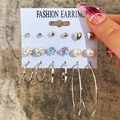 9-piece silver earring set featuring pearls, hearts, crystals, and hoops on a card - 9 Pairs Silver Rhinestone Pearl Set (EJ58025)