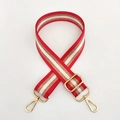 Detail of red and white nylon strap with gold metallic thread and shiny metal buckles - Red
