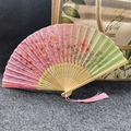 Pink and green gradient folding fan with cherry blossoms, bamboo ribs, and pink tassel - Cherry Blossom Dance - Peach Pink