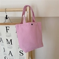 Close-up of a pink canvas lunch bag hanging on a wooden hanger in a clean setting - Pink (With Snap Button)