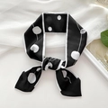 Polka dot black and white skinny silk scarf tied as a hair ribbon on white background - Black Circle