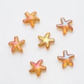 Macro detail of six orange-gold starfish glass crystal pendants for DIY jewelry making - Gold Rose Red