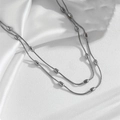 Silver tone double-layer snake chain necklace with smooth steel beads and silk texture - Double Layer Silver Snake Chain with Oval Beads (O309)