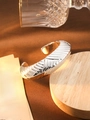 Silver open bangle with gold interior and textured diagonal stripes in a warm setting - L160 Silver 3D Irregular