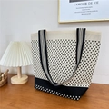 Detail of knitted houndstooth tote bag on wooden table with minimalist home decor style - 24 Small N Beige