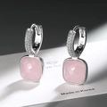 Detailed macro view of S925 silver hoop earrings with square pink gemstone and cubic zirconia - Pink