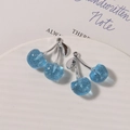 Detail view of blue glitter resin cherry pendants with silver stems for jewelry making - Silver Stem Glitter Blue / 1 Piece