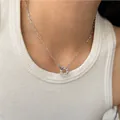 Detail view of asymmetric chain necklace with colorful enamel donut pendant on a model - Silver (PD758)