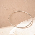 Close-up of sparkling multi-row rhinestone choker with adjustable lobster clasp on stone - Single Row Choker / Silver