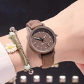 Close-up of minimalist brown quartz watch with matte leather strap and white numeric dial - Brown