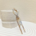 Close-up of marbled acetate U-shaped hair fork on a water-textured glass pedestal - Mermaid Pink Purple Large