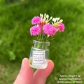 Miniature pink and white artificial flowers in a tiny glass jar with Good Luck label - [Luminous] Rose Red Vase