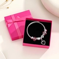 Silbernes Kronen-Armband mit rosa Kristallen und Herzanhänger in einer Geschenkbox - Mit Schmuckschatulle / Herz