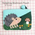 Handmade hedgehog and mushroom wool felt coin pouch with zipper and teal green finish - Hedgehog & Mushroom