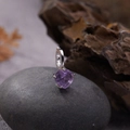 Macro detail of a purple heart-shaped gemstone pendant with silver claw setting - Natural Amethyst Heart Pendant Silver