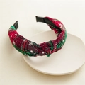 Detail of Christmas plaid wide headband with white stars and knot on ceramic plate - Twisted Knot / Red and Green Plaid (Star Print)