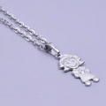 Detailed macro view of a silver stainless steel little girl pendant with grid texture - Girl Necklace - Silver