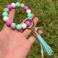 Detail of printed silicone beads and mint green tassel on hand-held keychain wristlet - Mint Green Floral Combination (A1)