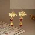 Detail of Chinese style ear hooks featuring golden leaves and elegant red beads - Gold Leaf Red Bead Hook Style (E6416)