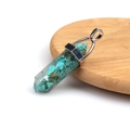 Hexagonal green gemstone pendant with silver cap on a wooden coaster display - Resin Turquoise