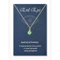 Golden stainless steel evil eye necklace displayed on a navy blue product greeting card - 18K Gold Green Bead (Black Eye)