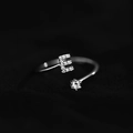 Adjustable silver letter E ring featuring micro-pave crystals and a round solitaire diamond - Letter E