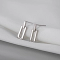 Macro shot of minimalist geometric rectangular S925 silver stud earrings on white fabric - 33# Silver Geometric Rectangular Minimalist Studs (33# Silver Earring Post-Silver-Square)