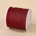 0.8mm nylon cord for jewelry making in burgundy color on a white spool - Burgundy