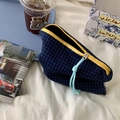 Detail of navy blue checkered makeup bag with yellow zipper and light blue cord puller - Blue and White Checkered Storage Bag