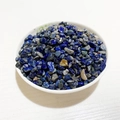 Polished natural Lapis Lazuli crystal chips in a white ceramic bowl, 3-10mm stones - Lapis Lazuli