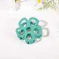 Detail view of a matte mint green flower hair claw clip with a hollow five-petal design - Hollow Five-Petal Flower - Matte Lake Green