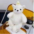 Cute white polar bear plush backpack with yellow straps on a transparent chair - White