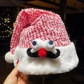 Plush Christmas hat with knitted character design, big eyes and red nose detail - Santa Claus Hat