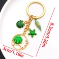 Golden keychain with green enamel starfish and shell charms, length 8.3cm/3.26in - Green Shell Conch Keychain-LS557