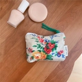 Detail of vintage floral cotton pouch showing textile texture and green cord zipper pull - Retro Red Floral