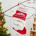 Large red Christmas stocking with embroidered Merry Christmas and plush Santa Claus hanging - Alphabet Santa Stocking