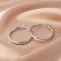 Polished silver hoop earrings displayed on champagne silk fabric background - E066 Platinum 40mm