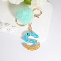 Blue resin letter S keychain with gold foil, light blue stones and mint green pom pom - Letter S