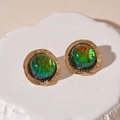 Detailed macro view of vintage green resin round earrings with golden sunburst texture - Green Resin Round (Silver Pin)