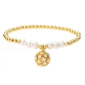 Macro shot of gold-plated metal beads with white pearls and a hollow star-shaped pendant - White