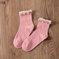 Pink cotton crew socks with white lace trim and pearl bead accents on wooden background - One Size / Retro Pink