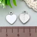 White enamel and silver texture heart pendants shown with ruler for size reference - 1Pc White Heart