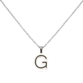 Macro shot of silver stainless steel letter G pendant with black enamel filling detail - Letter G