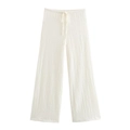 Detail view of white wide-leg trousers featuring drawstring waist and seersucker texture - White Pants