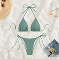 Sage green ribbed bikini set with halter triangle top and side-tie bottoms on a beach flatlay - Green
