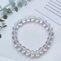 Single 8mm iridescent cat-eye glass bead bracelet with colorful shimmer on white background - Imitation Moonstone