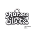 Macro detail of silver nurse hat pendant engraved with Nurses CALL THE Shots text - NURSES CALL THE SHOTS