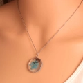 Macro detail of bohemian butterfly glass pendant with real dried flowers on silver chain - Silver Blue